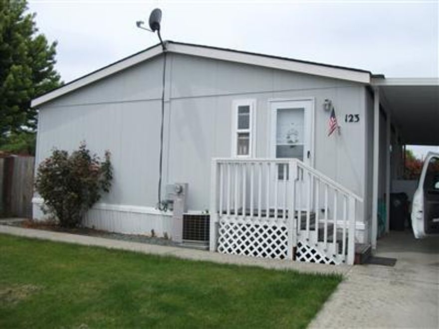 Priced for quick sale. Cute double wide with all new, easy care laminate floors throughout. Vaulted ceilings, split floor plan, open kitchen and indoor laundry room. This home is located in all age park, Peachwood Village. Quiet street, large fully fenced yard and close to new high school. Covered 2 car carport and storage shed.