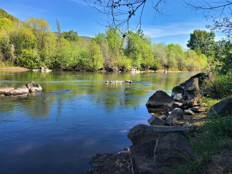 This is one of those gems that offers so much to the new owners! A peaceful, tranquil setting, amongst a beautiful and mature landscaping, with the Rogue River in your backyard. Take a moment to sit at the picnic table and watch the drifting lazy river, while abundant geese and ducks fly by. Witness the catch of a salmon/steelhead in the well known spot the older timers call the ''Silicon'' hole! Or cast in a line right from the bank and hook in to your own lunker. Take in the views from the main level deck or glance out many of the large windows facing the river from inside the home. Fully functional, clean and move-in ready home, with so much potential to create exactly what you desire to have with a riverfront property. Ample off-street parking with plenty of room to add a garage if needed. Nice sized shop which may be a great conversion for an Airbnb with its own access. Endless possibilities or just move in and begin to enjoy what so many desire to own right here in S. Oregon.