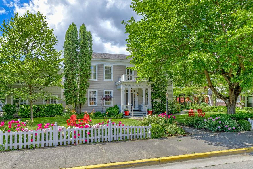 The luxurious McCully House is nestled in the heart of Jacksonville Oregon's Historic District, a designated National Historic Landmark and one of the nation's top 10 small towns. The inn is the oldest home in Oregon currently operating as an inn and has been featured in both Sunset & Gourmet magazine. The home was built in 1861 by John McCully, Jacksonville's first doctor & Justice of the Peace. The boutique inn offers six distinctive deluxe guest rooms and three luxurious suites, as well as a large wine bar/restaurant and full commercial kitchen. Every possible attention has been paid to the smallest of details. It has all the amenities you would expect in a metropolitan setting but is situated in a convenient downtown location on ¼ acre and includes a flourishing English garden and a private outdoor patio area.