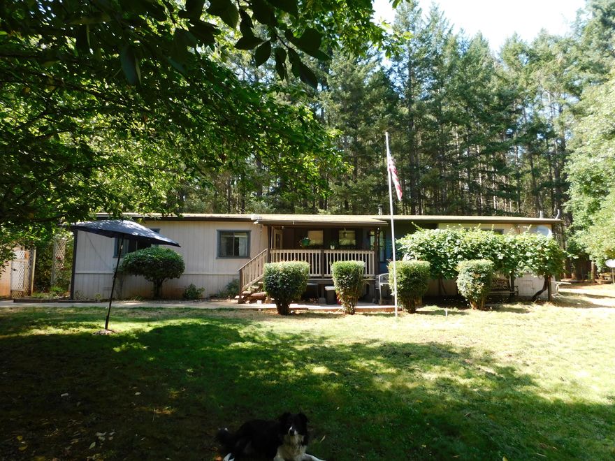 Move in ready home on 2.5 flat, usable acres. This home features over 1800 sf of living space, with an open concept, a split floor plan and two full bathrooms.  The kitchen is a nice size and has two pantries. Outside there is a 2 car garage as well as several other smaller outbuildings.  The back deck is 4 years old and offers lots of room to relax and enjoy the outdoors.  This property is partially fenced but the large yard surrounding the home is completely fenced.  Cement sidewalks make it easy to access the different areas and there are lots of fruit trees including fig, apple, cherry, pear and plum.  Grapes also adorn the arbor next to the front deck.   Upgrades include fresh painting inside, HVAC is 7 years old, carpet is 5 years old and the kitchen cooktop is 5 years old.  The certified woodstove and included firewood, on the back porch, are sure to keep you nice and cozy in the winter and give a nice ambiance.  Must see this great property!