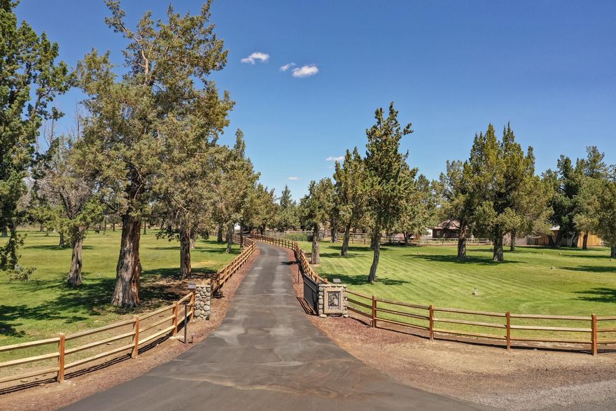 Room to relax in this stunning 9.50 acre setting with 6.5 underground irrigated acres making everything green and lovely. Classic single story ranch home with vaulted ceiling, sunken living room,  beautifully updated bathrooms, granite tile counter tops, double oven, Thermador cooktop, stainlees steel fridge, central AC, 14 solar panels on the 48 x 48 shop roof, a 36 x 48 machine shed with electricity, 36 x 72 horse barn with 6-10 stalls and tack room with grooming area, a 36 x 24 carport, a 12 x 36 horse shed, a cute dog house that could be your chicken coop,  perimeter and cross fencing and the green green grass of home! Huge patio  with stylish pavers for outdoor relaxing and entertaining. This is exactly where you want to come home to each and every day!