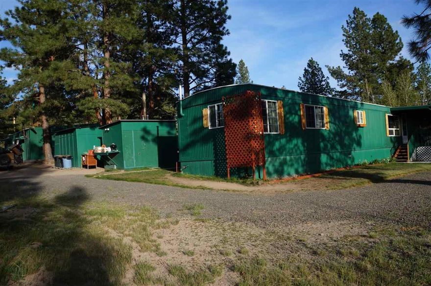 This Manufactured Home Is In Good Condition With Large Family Room And Extra Room That Could Be A 3rd Bedroom. Nice View Property With Extra Outbuildings. Chicken Coup And Large Greenhouse A Shop And Garage Combination And The Property Is Fenced. Great Setting With A View In The Pines. Nice Location Near The End Of A Cule-sac. Privacy Is Great And Room For Animals.