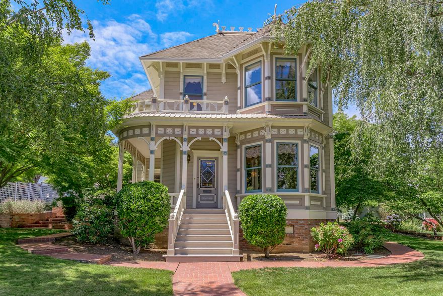 A highly visible part of Ashland's architectural heritage, this Italianate style home was built adjacent to the downtown commercial district in 1890 for Kate Grainger and G.M. Grainger, a two term Ashland mayor, who oversaw significant community growth including the construction of City Hall. When building was completed by architect W.J. Schmidt the home was called one of the prettiest cottages in town by the Ashland Tidings. The main house has two levels and features 3 beds and 3 baths with 10' ceilings throughout. The attached guest studio is single level and includes 1 bed and 1 bath. Stylistically unique in the neighborhood with a two story bay with turret and a curved veranda the home is in great condition having maintained the original period details including Fir flooring, wood paneling, and 10'' baseboards with molding. Newer updates include a spacious tile patio, two separate 2-car garages, and a modern foundation. The oversize .46 acre lot may be split according to the city.