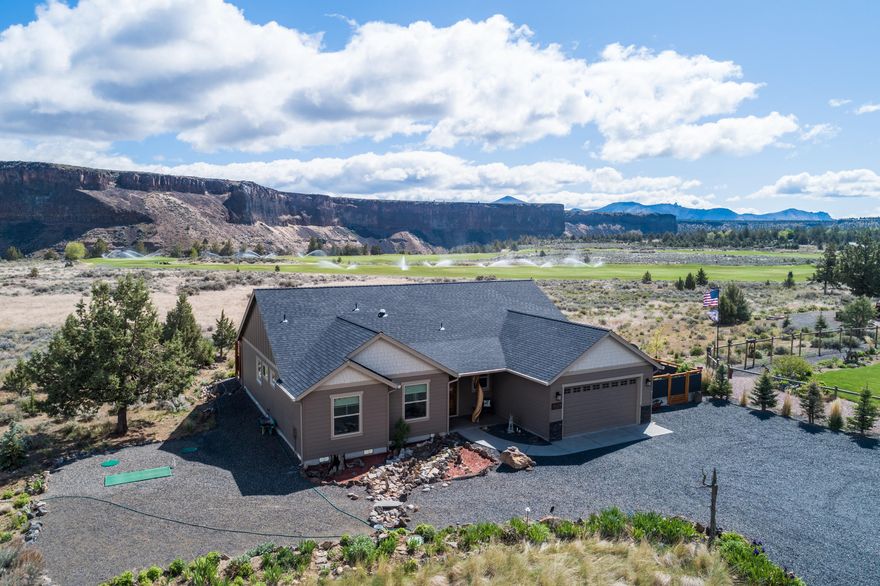 ON THE GOLF COURSE, Newly built at the direction of a discriminating owner. This 3 bedroom home provides all you could hope for; custom cabinetry, granite, hardwoods and tile, beautifully finished with gracious vaulted spaces. The property, with rare golf course frontage, has stunning Crooked River rim and golf course views, through a wall of floor-to-ceiling windows. Artistically designed, low-maintenance landscaping, as well as a fully fenced/gated courtyard-garden, blend beautifully with the natural rock exterior accents and aggregate concrete patios and walkways. Interior spaces include walk-in closets, kitchen pantry, luxurious master en-suite with double vanity, soaking tub and 5' tile shower, with frameless glass shower door. A tiled gas Fireplace provides a cozy ambiance and a 11'X16' heated, studio/hobby room/shop that gives you just enough extra space, with access from attached garage and courtyard, coupling the practical with elegant serene space.
