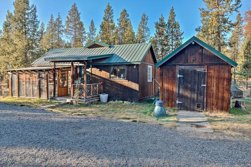 This one of a kind cottage style home is situated on a level forested double lot for for a combine total of 1.2 acres. The home has had a multitude of quality life improvements over the years which includes a full remodel, enclosed sun room, as well as multiple outdoor storage buildings and workshops. Just a few minutes from highway 97 this home is positioned in the line of progress for new city improvements including an upcoming project for public water and sewer systems for the entire neighborhood. With the included secondary lot there are a multitude of development opportunities for an ADU or secondary residence.