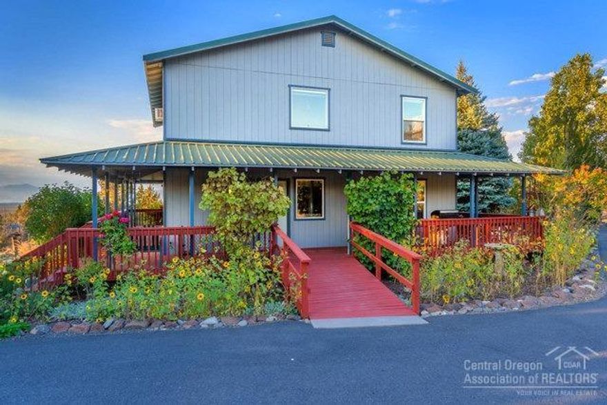 Private secluded setting w/valley & mountain views on over 2 acs just minutes from town. Well built & maintained 2048sf, 3bd, 2ba home nestled amongst beautifully landscaped & fenced yard. Large detached garage/shop w/double doors & RV parking area alongside. 400sf storage building with french doors has many options. Green house + compost tumbler & a fort for the kids! Numerous flowers, trees & grapes compliment the landscaped grounds. Large wrap around covered porch allows extended outdoor living. No HOAs.