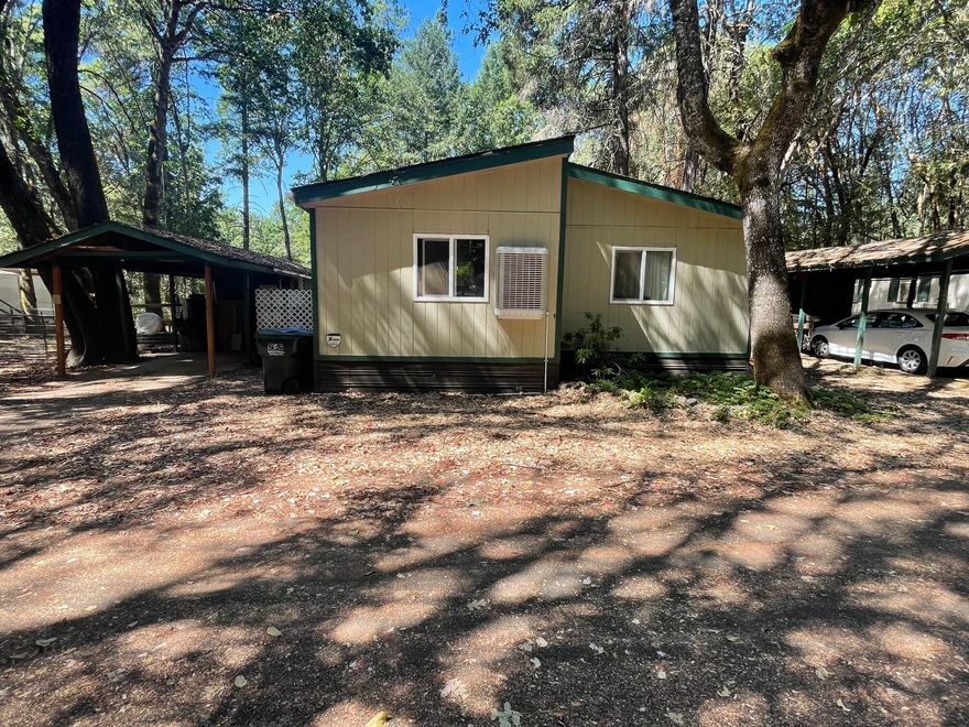BACK ON MARKET NO FAULT OF HOME. This rare find is move in ready! The park has a quiet and peaceful atmosphere with friendly neighbors who look out for each other under the canopy of Pine, Oak and
Madrone trees. Just 30 minutes outside of Grants Pass, and 15 minutes from Cave Junction this home is a short drive to town. Nearby attractions include the popular
Illinois River, the Oregon Caves & Just 90 minutes from Brookings. The home has a fully fenced backyard with a trailer gate, a 10x8 Storage Shed & covered carport, front
deck and beautiful large fire pit. Inside features an open concept living area with vaulted ceilings & new flooring. The brand-new Master-Cool Swamp cooler keeps the
space extremely comfortable. Guest bathroom has been fully renovated and upgraded. Both bedrooms are spacious. Roof is less than 5 years old. Tour today!