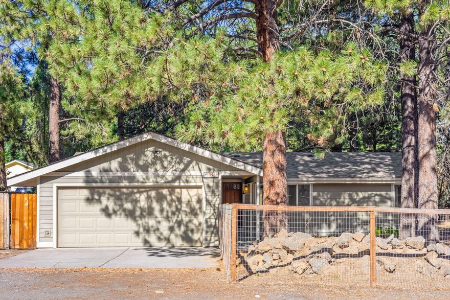 Affordable and adorable on almost an acre! Brand new interior paint and beautiful luxury vinyl plank floors at this gem in DRW. You'll love the fully fenced yard (approx. 1/2 acre), beautiful Ponderosa trees with chattering squirrels and room to spread out. Open floor plan with 3 bedrooms, 2 baths - and great separation between Primary and other bedrooms. Large Primary closet and en suite bathroom with corner soaking tub and walk in tile shower! Deck off of rear slider would be great for summer BBQs, and yard is a blank slate ready for your garden planters and landscape design. From separate (2nd) driveway, access the 'bonus room' behind the home - approximately 280sf bonus room with electricity, a full sliding wall, and nearby water and septic...could become an incredible art studio, home office, additional dwelling space and more! So much potential...Come walk this property and watch your dreams take shape under the pines!