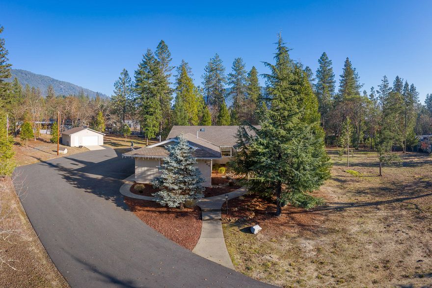 Paradise found in Colonial Valley!  Down a quiet street, sits this special 2757 sqft, one level home on a 1.09 acre lot that offers open areas & trees where you can enjoy nature from season to season! Welcoming front entry leads to a comfortable living room w/ tile fireplace & bay window, dining room w/ built in cabinetry & the ideal kitchen w/ large island & tons of cabinet space!  You will love the breakfast room w/ floor to ceiling windows overlooking the property plus the Family room w/ wet-bar perfect for entertaining family & friends. The spacious floorplan comes complete w/ an office & three large bedrooms which includes the Master Suite w/ walk-in closet & an ensuite bath. Don't forget the wrap around deck, paved circle driveway, 3 car attached garage w/ work area plus the detached 2 car garage/shop & RV Parking! All conveniently located minutes from schools & shopping, w/ easy access to I-5! Wrap it all up w/ a pretty bow & buy this gorgeous home before the Holidays are here!