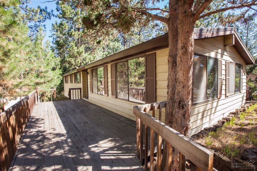 Vintage charm abounds in this one owner 1972 manufactured home nestled among mature trees on a .31 acre lot. Close in SW Bend, spacious rooms,vaulted ceilings,big windows,built ins, plenty of storage.This home boasts great retro appeal and very unique details. Detached oversize two car garage for storage and ample outdoor decking for entertaining. Please note it is not financeable due to age.$2k carpet allowance and home warranty included.A little paint and new flooring will go a long way with this one.