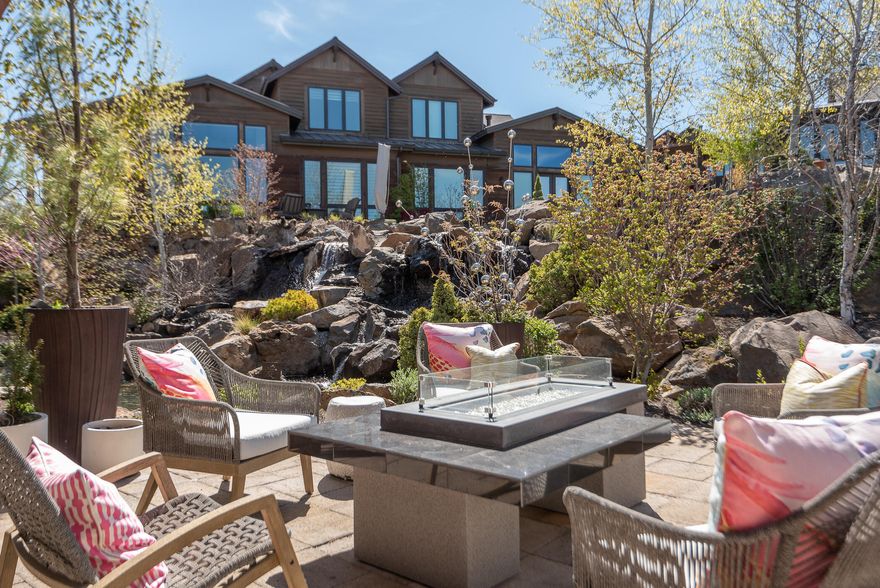 Now is the time to live a carefree lifestyle at Tetherow, Bend Oregon's premier resort and golf community. This single level TripleKnot townhome backs to the neighborhood common area with a pond and waterfall which creates a stunning, serene setting. Enjoy entertaining with a wonderful great room that flows seamlessly to the extra large patio. Simple lines, a well designed floorplan, upgrades and quality finishes make you feel at home the moment you enter. A chef's dream, with custom kitchen cabinetry, abundant storage and double quartz islands. The contemporary gas fireplace in the great room creates a relaxing space. The primary suite overlooks the pond and waterfall, a fabulous bath with separate vanities, a walk-in shower and a gorgeous walk-in closet. Second master suite offers a soaking tub in addition to a shower. The large bright den can double as a third sleeping area if needed. All Tetherow amenities are just steps away as is the national forest and Mount Bachelor!