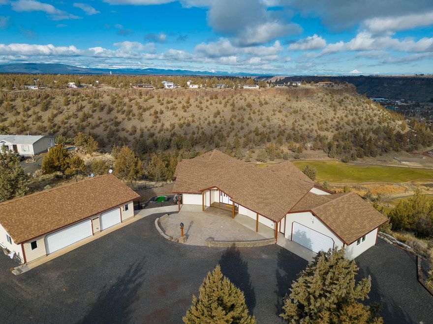 One in a million views of Cascade Mts & golf course from this1800-1850 sq ft custom home. A great deal of thought has gone into the low maintenance, but tasteful landscaping, throughout the 1.72-acre lot; RV-pad, concrete walks & beautiful paver/stamped-concrete entry. Enter home onto beautiful travertine-tile flooring & focus on birds-eye view of Mt Jefferson. The kitchen features stainless appliances, pendent & recessed lighting, hickory cabinets w/pullouts for everything imaginable, in addition to large walk-in pantry and kitchen island. Large dining space hosts a beautiful hickory buffet, w/loads of storage as well. Propane heating stove is perfectly placed to heat entire living space! The totally finished 593 SF double garage houses both car & truck, w/room to spare. Second 1280SF garage/shop houses 3 cars, w/full, heated bath, concrete floors, & huge workbench, w/lower cabinets, peg board wall to organize your tools & 220 power! It's a beauty any way you look at it!