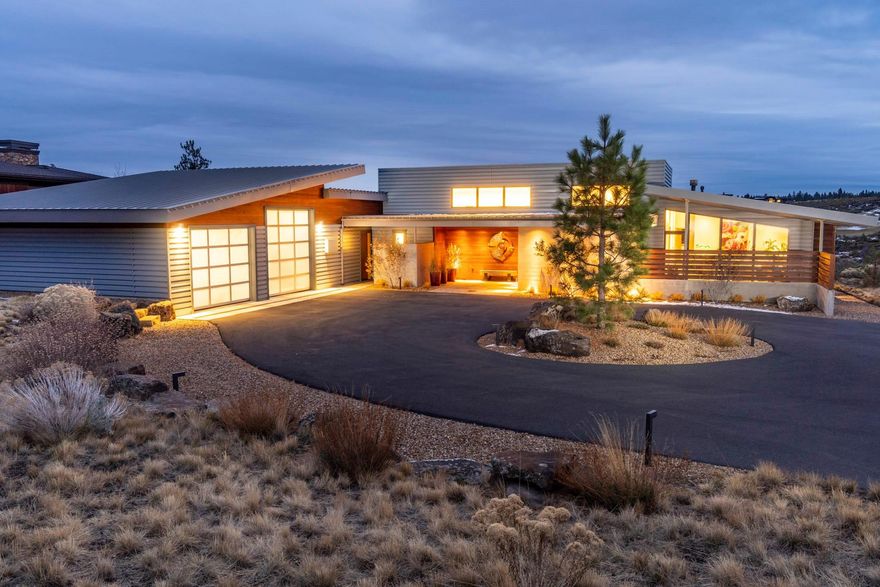 Set back off the road along the golf course in Tetherow, this single-level home harkens the modern yet warm aesthetic of Scandinavia. Natural light fills the home through floor-to-ceiling and clerestory windows, and fold-away accordion doors open wide to bring the outdoors in. The well-appointed kitchen features an island w/ waterfall edge and pass-through windows that open to the patio bar for entertaining. The great room features a modern two-sided FP. This U-shaped home features an owner's suite on one side and guest rooms on the other. The owner's suite has golf course views and offers a walk-in closet and a bathroom with tile shower. Three guest bedrooms include a bunk room w/ 4 built-in bunk beds. Outside, a large courtyard overlooks the expansive golf course views while offering privacy from neighbors. Other features of this home include rooftop solar, radiant floor heating in 2 bathrooms, and a built-in sound system. Garage includes a door for a camper van and 240V power.