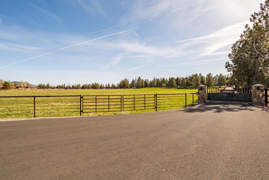 This beautiful Tumalo property welcomes you with it's large rusted steel/hammered copper gate & steel fencing that surrounds 19 acres. The private driveway leads to the 3 bedrooms/3 bath house that's fully updated. The large foyer, tall ceilings, open concept & gas fireplace welcome you into the two living areas, separated by an open kitchen/dining area, with a wine room .The Primary has a large bathroom & 2 walk-in closets. There's a large bedroom with a private entrance, porch, walk-in closet & dedicated bathroom. From the front room you'll see Mt views & a fire pit & private seating area. Outside offers 15 acres of irrigation (9 acres in ground) ,a canal running through the back yard, a large pond & a 6 acre pasture out front with half mile riding track. The Barn offers 5 stalls each with their own runs, a tack room & separate feed room. There is an outdoor roping arena with a new 4 Bar P horse exerciser. The 1,728sf shop has 4 oversized doors & a 864sf finished & heated room.