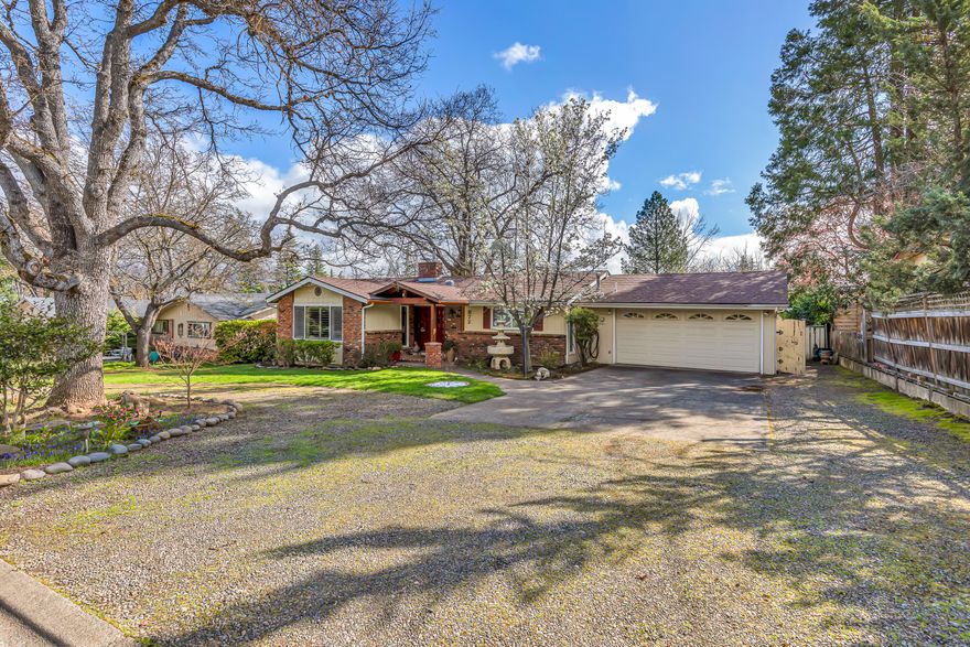 Location, location, location!! Looking for a single level home in a safe neighborhood of Ashland? If so, this is the one for you! This charmer features 3 bedrooms, 2 bathrooms, open floor plan, spacious kitchen w/ granite countertops, ample soft-close cabinetry, & stainless steel appliances, bamboo flooring, large primary bedroom w/ a walk-in shower & dual vanities, attached 2 car garage w/ an attached workshop area, gas fireplace in the sunken living room, woodstove in the dining area, wooden deck that overlooks the fruit trees and garden beds, circular driveway, & much more! Roof is less than 5 years old and HVAC was recently installed so no need to worry about any major expenses in the near future. Perfect opportunity for anyone that wants to move to Ashland and enjoy everything Southern Oregon has to offer, so contact your agent today for a personal tour, before its too late!