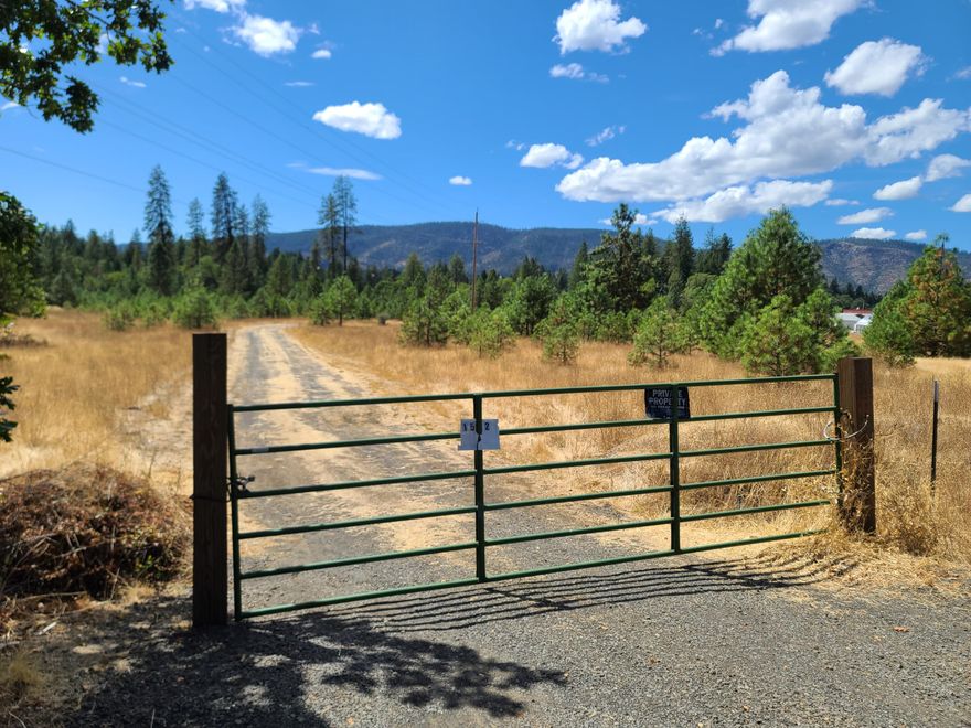 OWNER TERMS AVAILABLE TO QUALIFIED BUYER! Explore the potential of this 12.96-acre partially wooded property in Cave Junction that is situated adjacent to the city limits and within the urban growth boundary. Currently zoned RR-5 the home sites are Automatic, property is currently 2 tax lots and with a lot line adjustment it could be two really nice shaped parcels. Additionally, there is the possibility of annexing the property into the city and creating a subdivision to accommodate the current growth being seen in this area. This parcel offers the convenience of being close to the town center, Illinois Valley High School and the Oregon Caves. The land is fully fenced with electricity and a newly drilled 40 GPM well. This an ideal spot for your next investment venture or a great place to build and call home.