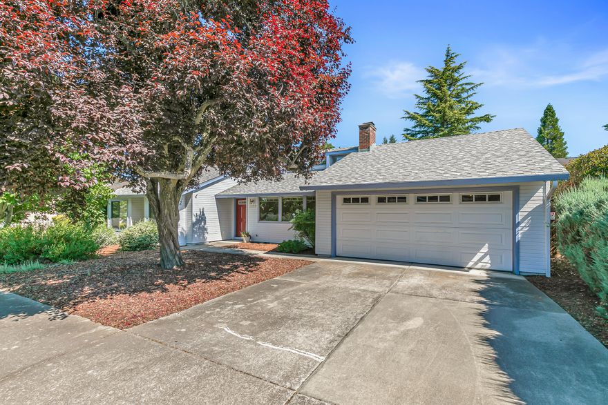 Tucked away in a quiet East Medford subdivision, this inviting home offers a nice blend of comfort and recent updates. Inside, you'll find fresh touches throughout—including brand new carpet in all three bedrooms as well as updated LVP flooring and a new shower stall in the primary bathroom. The spacious living room features vaulted ceilings and a cozy wood burning fireplace, creating a warm, open feel. The kitchen offers classic wood cabinetry and an efficient layout that's both functional and easy to personalize. Enjoy peace of mind with a brand new composition roof installed in 2025, and a water heater replaced in 2015. Step outside to a fully fenced backyard surrounded by mature trees and tall hedges—your own private oasis. An oversized two car garage allows for plenty of extra storage space. Clean and move-in ready, this home is a great find located in a convenient neighborhood close to shopping and medical services.