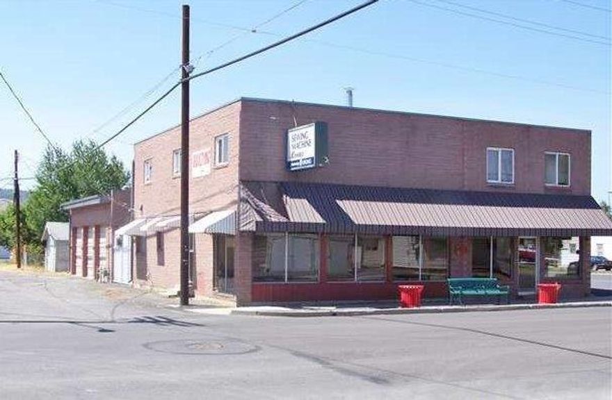 Multi use building available for almost any purpose. Store fronts on E Main and is visible from S 6th Street. Sq Ft includes bays and 2092 sq ft 3 bed/2 bath apartment upstairs to live in or rent out as it has it's own separate entrance. Excellent location for commercial operation with it's own paved off street parking and street parking. Other features include a 3 bay heated garage/shop and a 3 bay carport.