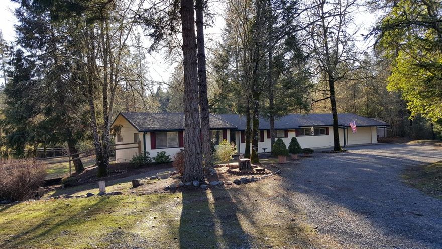 Get ready for this. Backed up to 45 Acres of BLM land this home spot might be yours! Surrounded by Trees and close to the Rogue River and wilderness and everything outdoors. Home is all one level with a family room and separate living room which could be guest qtrs. Its that big or entertain. Home has many modern updates with flooring, paint, fixtures and more. There are storage areas thru out the home and you have a workshop/Garage and extra 12 x 14 outbuilding for your extras. All fenced in backyard for your pets and low maintenance. Circle driveway entry with RV parking and hookups. There is another area you could also put another Shop or Garage. Lots of parking and usability on this very well kept home. This is not a drive by so be sure to tour this one. This one is a nice catch.