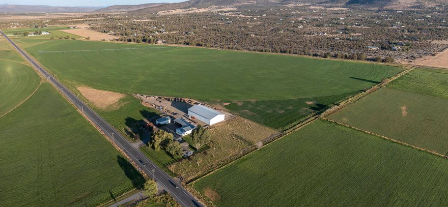 Premier Hay Property with 9,000 sq ft hay shed, stores 1,000 tons! Cascade Mtns frame this 108 ac w/98 irrigated by 1/2 pivot, flood & some handlines. Weeping Willow showcases updated farmhouse, 2016 sqft, 3 bed, 2 1/2 ba, kitchen w/lg island, quartz counters, tile floors, open kitchen, dining & living rm. Lg utility w/pantry & 1/2 bath, mudrm w/tile plank flooring. Dining rm opens to lg gabled paver patio. Spacious master w/access to patio has lg walk in closet, bath w/tiled shower, tiled floors, dbl sinks & quartz counters. Western flair greets you as you enter the permitted salon built in 2013. Constructed w/Malaysian wood siding & Corten Metal Roof, open concept w/3 stations, kitchen, utility area & ba. Accented w/rustic details & vaulted wood beam ceilings. Property also includes 4192 sqft Machine Shed/shop, 1248 sqft hay shed, det dbl garage, corrals & more. Mature landscaping includes cement rail fencing around yard. Property is fenced & cross fenced w/several pastures.