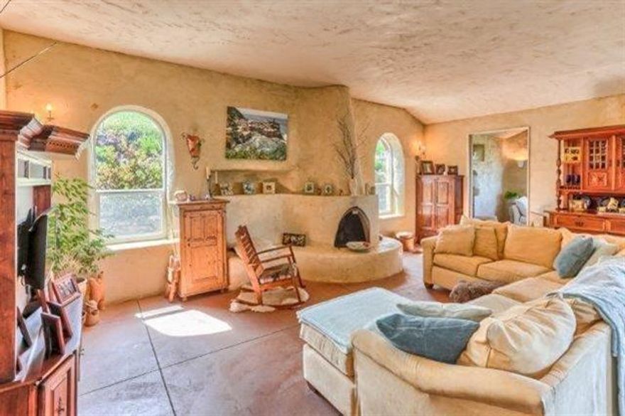 BREATHTAKING VIEWS and a picturesque setting provide the ideal backdrop for this custom built Tuscan style farmhouse on 6.82 AC. The 2054 sq. ft. single level home also has a 600 sq. ft. detached office/cottage not included in the square footage of the home. The home features hand crafted stucco walls thick and highly insulated, warm patinas, radiant floor heating , arches, wood burning fireplace, leaded glass windows with view out of every window, several doors open to patios and verandas, and a tile roof protects it from fires. This is a green'' home , energy efficient, and healthy home. The floor plan is open with the living room, dining area and kitchen sharing space. There are 2 bedrooms, 2 bathrooms, and 1 library/office room. The land is beautiful, has a 2-car carport, solarium/greenhouse, waterfall and pond, could be good for grapes, lavender or just to enjoy the privacy.