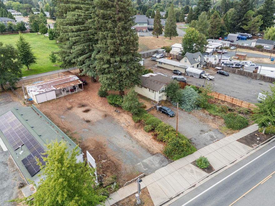 1461 Rogue River Hwy offers two income-producing homes on one tax lot with GC zoning. The main 2-bed, 1-bath, 994 sq.ft. home features 1940s charm and a covered patio, while the 2-bed, 1-bath, 630 sq.ft. mobile provides additional rental income or live/work flexibility. Each residence has its own address, driveway, and abundant parking. Current tenants are month-to-month with a strong rental history. General Commercial zoning allows for a variety of uses—daycare, office, repair, multi-dwelling, retail (buyer to verify). Conveniently located near schools, parks, businesses, and downtown. Potential to split lot with city approval.

All information deemed reliable but not guaranteed; buyers to perform due diligence.