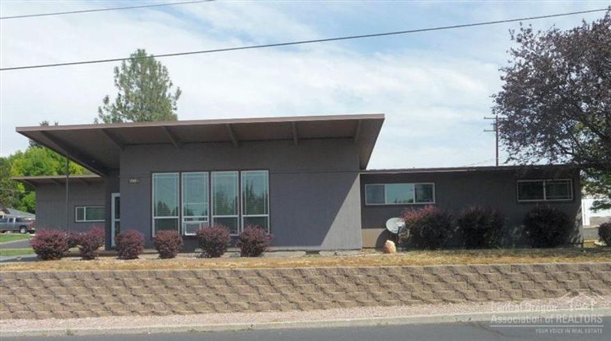 Unique mid-century home on Ochoco Heights. Spacious living room with beamed ceiling & rainbow rock fireplace open to dining area. Roomy kitchen with breakfast bar,large laundry has deep sink & extra storage. Quality features include: built-ins & storage throughout, vinyl tinted windows, newer high-grade vinyl flooring, cedar siding & lifetime metal roofs on home and shop, landscape block retaining wall & vinyl fencing. Private back yard, large patio, extra parking off alley.