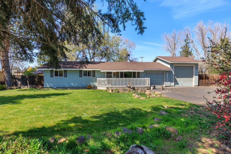 Charming ranch-style home on a private ½-acre with tip-top mountain views from the yard—and even a peek from inside! Thoughtfully updated and full of natural light, this 3 bed, 2 bath, 1,428 sq ft home offers easy indoor-outdoor flow and a peaceful, country-like setting just minutes from town. A sunny family room with picture windows overlooks the backyard oasis, while the cozy living room features a wood-burning stove for chilly evenings. The refreshed kitchen includes a breakfast bar, newer counters, and opens to the family room—perfect for gathering. Outside, enjoy raised garden beds, a greenhouse, multiple storage buildings, and space to roam. Well-maintained with a new roof in 2025, newer exterior paint, RV parking, a single-car RV garage, and plenty of room for toys. Simple, solid, and serene.