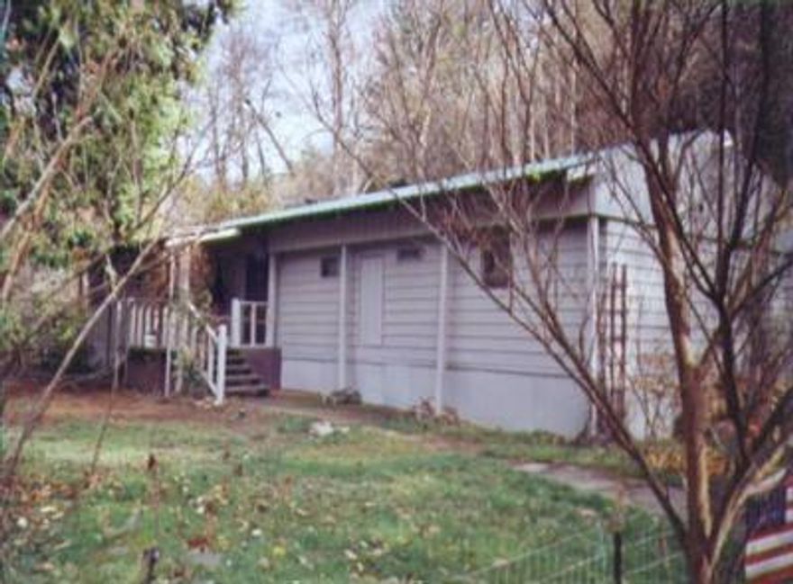 Unbelievably Nice For The Money! So Much Has Been Done To This Home, It Seems More Like A Site Built. There's 2 Wood Stoves In Home & One In 2 Story Shop Or Storage. Shop Has Balcony W/Anderson Creek View. Super Privacy From 199, Lots Of Trees &