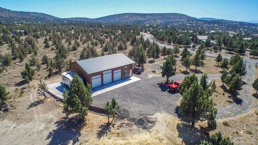 Over 2 acres of country living with mountain views just minutes from town! Huge 48'x 36' shop 3 roll up doors and 200 amp service. Studio is nicely finished with hardwood floors, travertine tiled bathroom and full kitchen. Upstairs there is an unfinished bedroom. Site is ready to build your dream home with extra septic hookup, 200 amp service and house plans. Large outdoor RV pad with hookups and dump. Fully fenced w/ automatic gate opener. This is a great opportunity to live in nice studio while you build