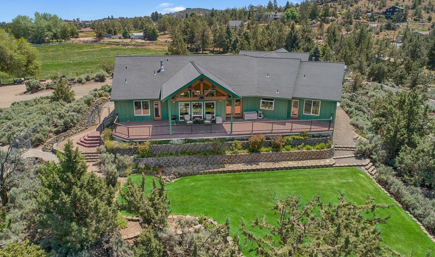 Just inside the Terrebonne city limit & 8 minutes to downtown Redmond. This property offers breathtaking panoramic views of the Ten Peaks Cascade Range, from Mt. Bachelor to Mt. Hood and is priced well under Appraised value from May, 2024! Sitting on 6.81-acres it includes 2.95 acres of COI underground irrigation for lush landscaping, garden areas & fields. The home is designed to highlight the breathtaking views with large windows in the great room, soaring wood-beamed ceilings and a cozy propane fireplace. The main level features a luxurious primary suite with a fireplace, a spa-like bathroom and a walk-in closet. Two additional bedrooms share a dual bath, plus there's an office or optional fourth bedroom. A large bonus room upstairs is perfect for entertaining. There is a 2,240 square foot shop with concrete floors, a 14' RV door, hookups & workshop. Solar panels on the shop roof power the entire property. Outside, enjoy beautiful landscaping, water features & stunning Mtn. Views!