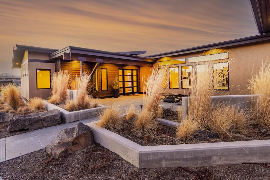 Take in the Cascade Range from this incredible contemporary home in Tetherow. Thoughtfully designed and built by Sunforest Construction, not a single detail was overlooked in this single-level stunner. The chef's kitchen features a large island w/ thick quartz slab countertops & seating for 4. The 48-inch Wolf range makes whipping up gourmet meals a breeze as you and your guests enjoy panoramic Cascade views. Open sliders to the expansive deck, where the incredible views can be enjoyed year-round, thanks to built-in deck heaters and a custom firepit. Enjoy local Bend brews from the double-tap kegerator in the den, which boasts a pvt patio w/ firepit, as well as a closet, should you need another bedroom. Retire to your well-appointed owner's retreat, featuring more mountain views, doors to the deck, and a luxurious walk-in shower w/ 7 shower heads for a true spa-like experience. At the back of the home, find two guest BDs, including a king-sized BD w/ mtn views from its own patio.