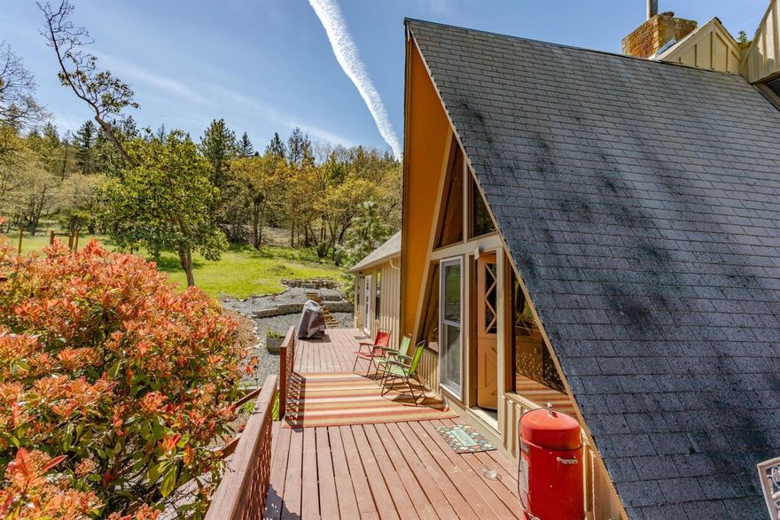 Country living close to town! Here's a sweet house on a great and manageable piece of property with quick access to Jacksonville. Light and bright inside, with many updates: new flooring, new master bedroom and a very cool master bathroom, new gas stove, new well pump and piping, new heat pump, new paint and more. End-of-the-road privacy with nice views. Fenced garden, lots of decking plus a detached garage/shop. Strong well plus holding tank. The living room features a gorgeous real rock fireplace with integrated grill, a certified wood stove, and you can gather firewood from your own property. Neat loft upstairs that is open to the living room. Two master suites on the main level. Central vacuum, saltless water softener plus a reverse osmosis system. Sliders to the deck help bring the outside inside. New firepit, retaining walls and decorative landscape add to the charm here. Come home to the country without travelling far from the city!