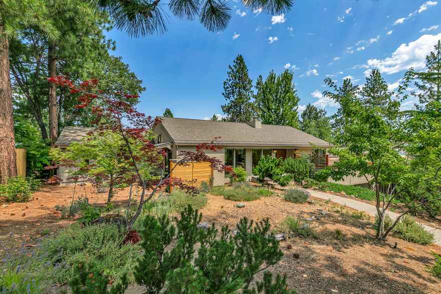 Tastefully renovated midcentury view home with new detached studio office, located near hiking and trail-riding just above Southern Oregon University! Great room with vaulted ceiling, exposed beams, gas fireplace with stone hearth, media area with built-ins and surround-sound, gourmet kitchen with stainless Thermador appliances including 6-burner gas cooktop, stone counters, butcher block island, skylights, and dining area with wood fireplace. Solid oak hardwood floors throughout main level - including primary with full ensuite bath, limestone vanity and shower surround, and walk-in closet. Two lower-level bedrooms with closets and new carpet, full bath with dual vanity, laundry mudroom or potential guest kitchenette, two storage rooms, and two-car garage. French doors from great room or primary to view deck, fully-fenced backyard with poured concrete and stone patios, and studio with metal-clad exterior, wood-paneled interior, and floor-to-ceiling windows. Inquire for details!