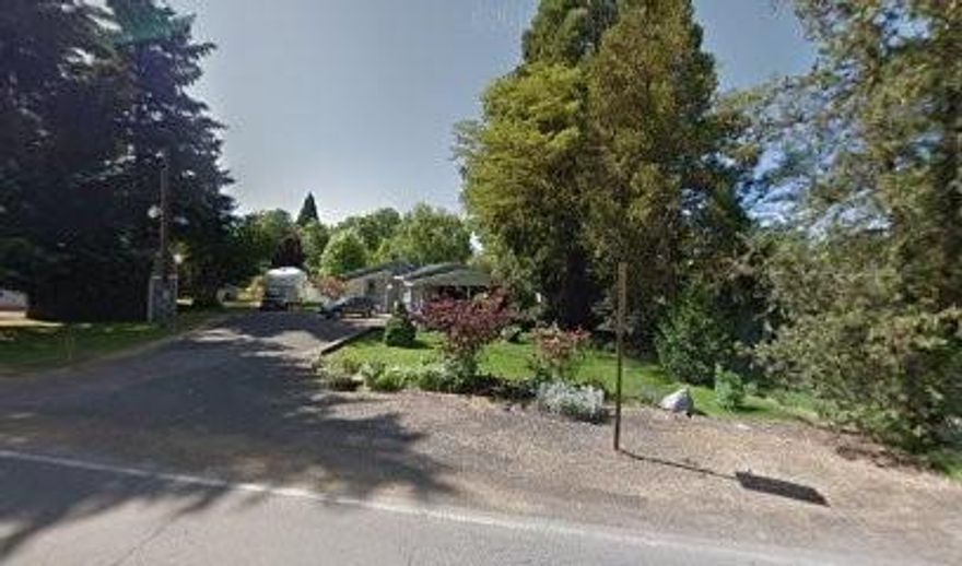 Waterfront 3 Bedroom 2 Full Bathrooms,solid wood floors were installed, Both Bathrooms remodeled, walk in pantry, Fireplace, natural gas heating with attached 2 car garage with Workshop & Covered Carport on over an half an acre  plenty of room for a garden and in ground irrigation, Fenced backyard,  with Little Butte Creek running through the back of the property.. Plenty of off street parking with room to park an RV Great location conveniently located to banks, stores, schools & post office