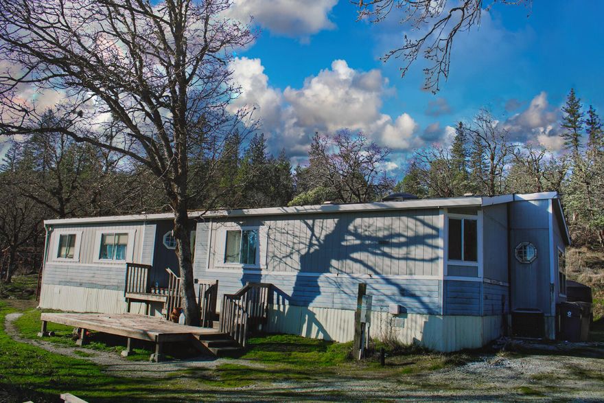 Are you searching for a spacious and peaceful property with stunning mountain views? Take a look at this 1988 manufactured home on 5.45 acres. The home offers three bedrooms and two bathrooms, providing ample space for you and your loved ones. This serene location provides a sense of safety and privacy, while remaining in close proximity to the downtown area of Grants Pass and I5. One of the most impressive features of this property is the views of the beautiful mountains that surround it. Enjoy the picturesque scenery from your backyard and savor the peaceful ambiance that comes with being surrounded by nature. Owner Carry Possible for creditworthy buyers Don't miss out on this amazing chance! Contact your realtor today to schedule a showing and experience for yourself all that this property has to offer.