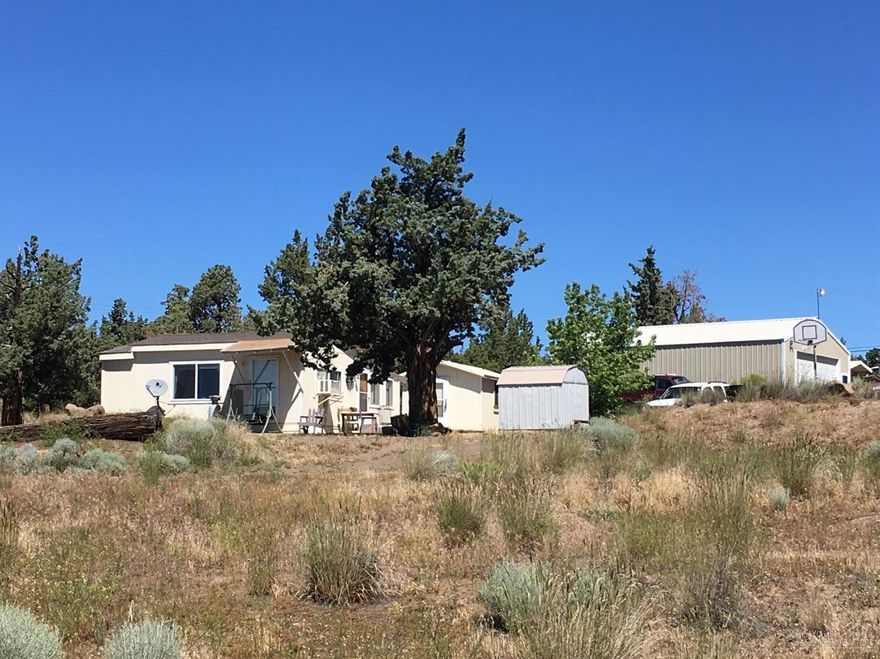 Breathtaking location between Bend and Redmond! This mountain view homesite comes complete with cozy cabin, bath house and 24 X 36 shop (864sf). Permitted septic system and power installed. Outstanding mountain and city views. Site has been prepared to build your dream home. Live in the cabin while you build, then keep the cabin as a guest house or mother in law quarters.