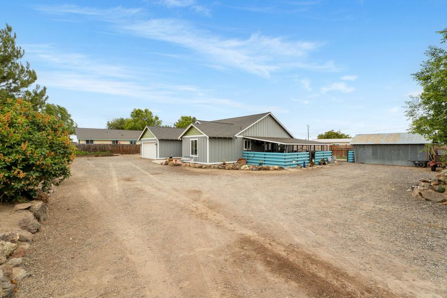 Discover the charm of country living with mountain views in Terrebonne! Tucked away at the end of a dead-end street, this 1,798 sq ft home offers the serenity you've been looking for- no HOA, no through traffic, just quiet surroundings and wide-open skies. Built in 2006 on a spacious .37-acre lot, this home features an open and airy layout with vaulted ceilings and hardwood floors throughout the main living area. With 5 bedrooms, including a dedicated office/home gym this home offers flexible options for remote work, fitness, or additional sleeping space.  The home also includes A/C, a QuietCool attic fan for added energy efficiency, and RV parking with water and sewer hookups. Outside, the property is fully fenced with a gated entry, fresh grass, and rock landscaping offering privacy, security, and plenty of space to enjoy the outdoors. Don't miss your chance to make this move-in-ready country retreat your own schedule your private showing today!