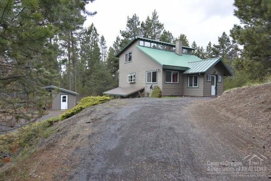 Chalet style home close to Big Deschutes River on .71 acres w/ RV parking, storage building, carport, pull through driveway & fire pit area. Vaulted and beamed tongue & groove ceiling, kitchen w/ eating bar, granite kitchen counter, updated kitchen cabinets, tile floors. Old growth redwood window trim, new vinyl windows, bamboo floors, propane fireplace in living room. Downstairs finished basement w/ radiant heated floor and a bonus room that could be made into a bedroom w/ separate entrance.