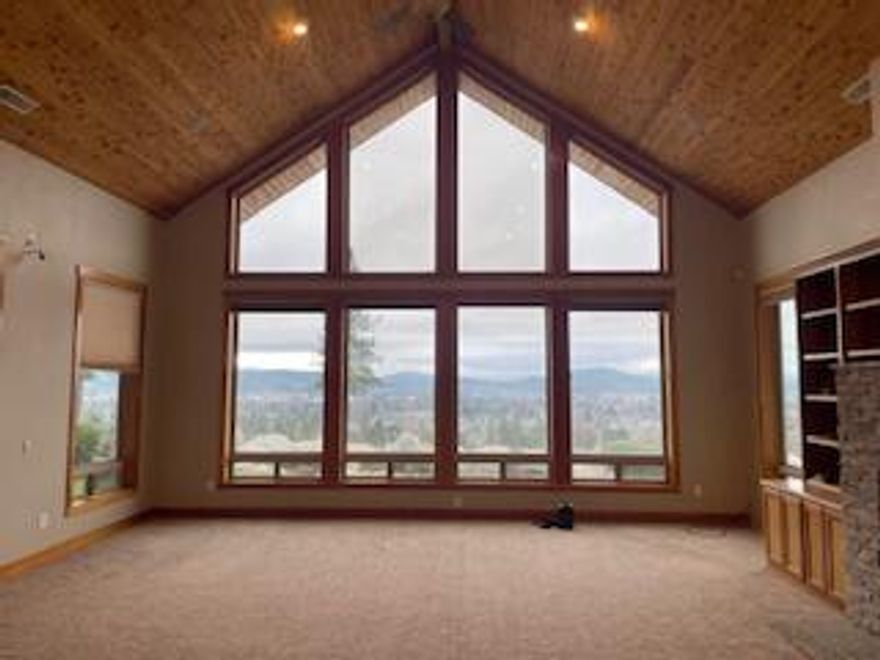 Top of the town views describes this one level Contemporary style home situated on just over One acre. Just minutes to down town shopping. Split floor plan adds extra privacy when entertaining guests. Owner has paid extreme attention to detail with this well appointed home. Gourmet kitchen, double islands, radiant heated floors to include front portion of garage. Owner says shop stays about 60 degrees in the winter, separate gas heating unit also in shop. Drive your 40 Ft. RV right into the covered 2200. sq. ft. shop that is attached to garage and house. Beautiful Cherry wood finishes as well as Travertine radiant heated tile throughout. Relax while watching the sunsets from this gorgeous home! It is priced to sell, below assessed value.