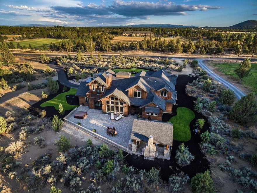 Welcome to your dream home in the heart of Bend, where every corner spells luxury and every view reflects nature. This grand, custom-built 4,208-square-foot home isn't just crafted with exceptional materials, but with the vision of a true artisan -- from the magnificent woodwork & stone masonry to the inviting multi-zoned outdoor entertaining space. The home boasts four ensuite bedrooms (including two ensuites on the main floor) and four full baths, making it an ideal option for both comfort and privacy. There's also a generous bonus room upstairs that provides multiple opportunities. For those with an eye on investment, the home has a Short Term Rental permit in place, plus years of lucrative annual income. This property sits right across from Pine Nursery Community Park, offering acres of outdoor bliss. The proximity to Highway 97 means you're connected yet comfortably tucked away from the hustle and bustle of the city.