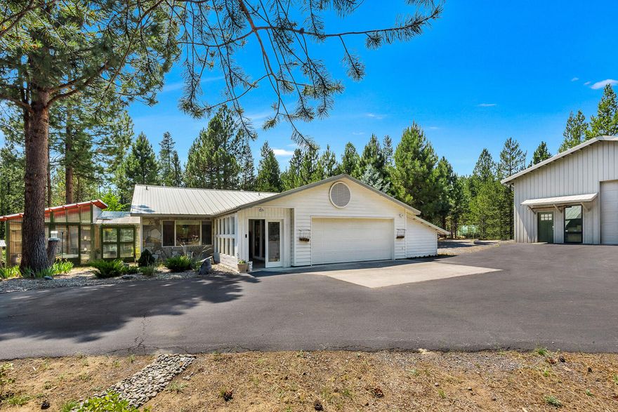 Beautifully updated single level home with charming Farmhouse accents. Enclosed entryway opens to oversized formal dining room with built-in cabinets. Spacious great room adjoins modern kitchen with eating bar & slider door leading to enclosed sunroom. Large master has walk-in closet, barn door & shiplap accents. Slider door opens to sunroom & provides access to additional outdoor spaces via chic Dutch door. Attached multi-room Greenhouse provides option for year-round gardening & outdoor living enjoyment. Expansive decking has covered & non-covered spaces overlooking the private & landscaped yard. Fenced & cross-fenced  backyard allows divided areas to host animals & more! Incredible detached 30'x 40' multi-purpose shop has oversized, fully finished office/flex space, workshop area, substantial storage & two huge RV doors for pull thru convenience. Fully paved driveway leads to quiet, 1+ acre lot with generous parking. See attached 3-D virtual tour to view this amazing property!