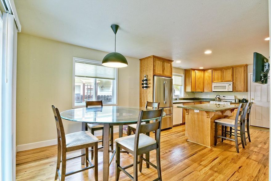 Fabulous Blackberry townhome set back of the street in a private location. This home was beautifully constructed by Santo Cominos, a well-regarded local builder. Sweet covered front porch and immaculate, light and bright interior. Rich hardwood flooring adds warmth and style to the spacious and open main living areas. Gas fireplace for winter evenings. Chef's kitchen with slab granite counters, island with dining bar, stainless refrigerator and abundance of cabinets. The kitchen is open to the dining room with a great layout for entertaining. All bedrooms are spacious and master suite features a walk-in closet and tiled bathroom. Previous tenant created wonderful rear yard space with potted trees, outdoor dining area and twinkling lights. Double car garage. You will love the way this home feels from the moment you enter.