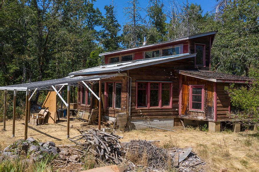 Northwest Style Timber-Frame Home on 5.58 Level Acres! This Home is well-built & attractive in design, & has great potential! The Home needs Cosmetic Upgrades & Updates & some finish work to complete the remodel that was in process in the Loft Bedroom Area. In addition, there is a Large app 3,000 Sq Ft Two-Story Shop Building, with Concrete Floors & Work Pit! A Fenced & Cross-Fenced Pasture Area offers Multiple Covered Animal Stalls & Sheds, plus a Storage/Tack Building. The Home is set well back off the road & is Private from Neighbors. Two Wells, one which was drilled in 2015 & shows 12 Gallons per Minute per Driller's Log. The coolest feature of this Property is the fact that it backs directly to 186 Acres of BLM Land with the Illinois River flowing through it! Hike, Explore & Horse-Back Ride directly onto BLM & be at the Illinois River in minutes! Cash on this one is best, but Owner will consider carrying with minimum $150,000 Down Payment. This special property is waiting for you!