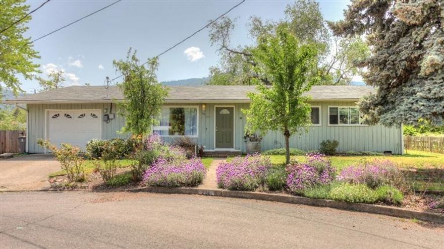 This deceptively large, charming, ranch home is located on a quiet cul-de-sac. With two offices, a library that features a vaulted ceiling, track lighting and french doors that lead to the back yard. The cozy living room includes a fireplace. The open family room/dining room/kitchen area is a great space for catching up with family members. The master bedroom has two closets, a bathroom, and french doors to the back yard. The spacious, fully fenced, back yard has plenty of room to add a vegetable garden. The extensive deck has a wonderful view of Mt. Ashland. In 2002, a new roof was installed, and the library and laundry room were added. At the same time, part of the garage was converted to use as either a TV room, playroom or a work space. This conversion can easily be undone. In 2012 bath fixtures were upgraded. In 2014 the hardwood floors were refinished in three bedrooms and an office, new paint throughout and new carpet installed.