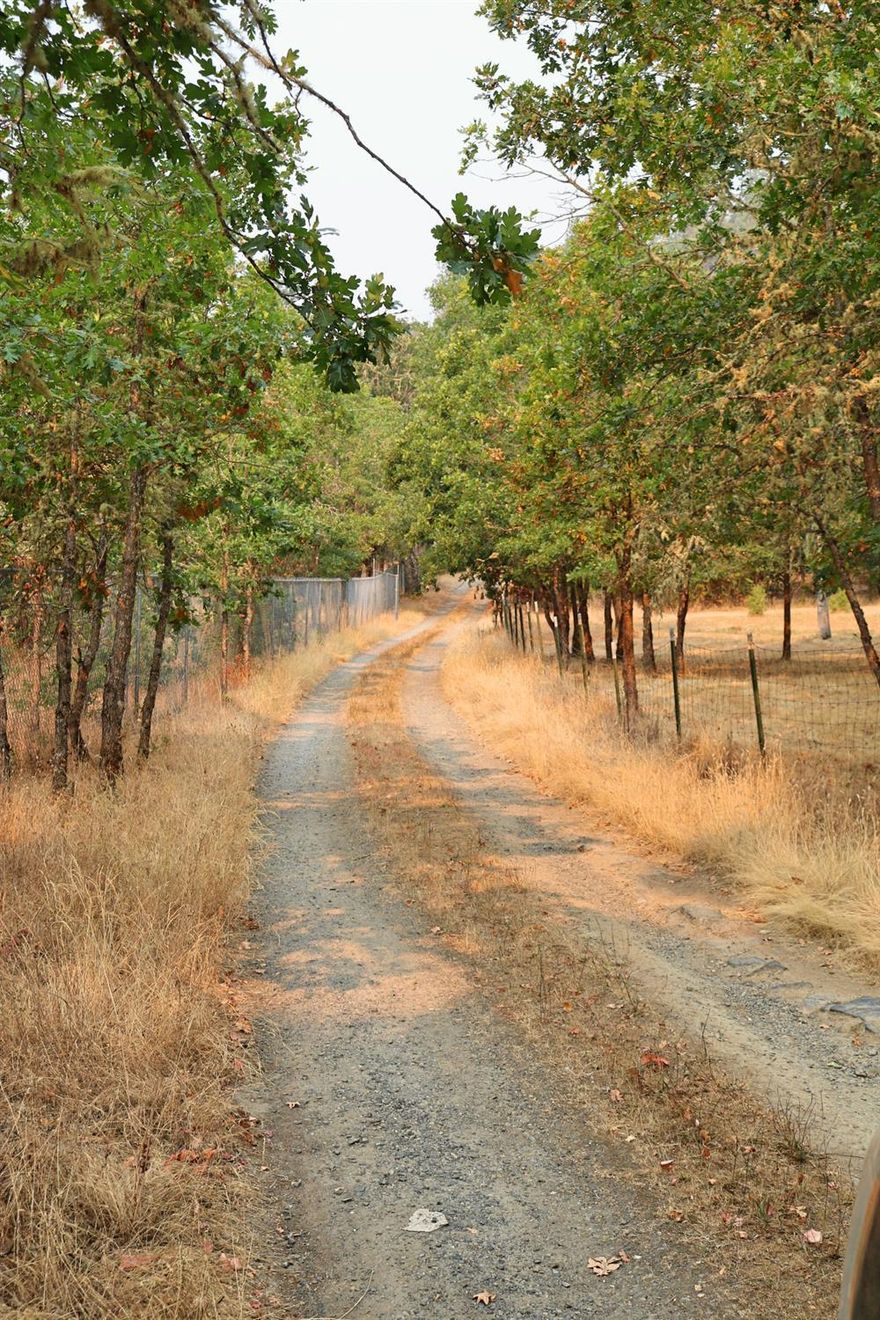 Imagine driving along the Rogue River and around the Birdseye Creek Vineyard every day. With a little work, you can live in this modest house while building you new home above the hill. All utilities are already in place, you just need your plans and contractor.New home-site allows for amazing views of the valley and mountains. Gated access, so this property is not a drive-by. You cannot see the current house or future home-site from the road.