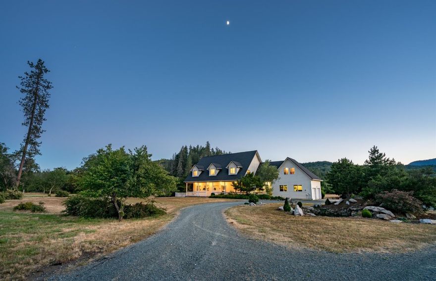 Located at the gateway to the Hellgate Canyon, this ranch offers 74 level acres with a year-round creek & water rights. The setting is picturesque with stunning sunsets to the west & wide-open views of the mountains. The entrance to the property is quite charming. The spacious contemporary farmhouse includes a well appointed main floor master suite, great kitchen, formal dining, office, large mud room w/bath & nice living room with French doors to the expansive deck. Upstairs is a 2nd living space with soaring ceilings, 2 identical guest suites that are huge, each w/full bath. Above the garage are 2 bonus rooms that are perfect for hobbies or more bedrooms. The 74 acres is fenced & is nearly all pasture w/cross fencing. Great swimming hole just a short walk from the home. The dairy barn is approx. 25,000SQFT & hay barn is over 2,000SQFT. There is a horse racing track that is approximately 6/10ths of mile. Incredible man cave which includes a retro bar, kitchenette, bathroom & more.