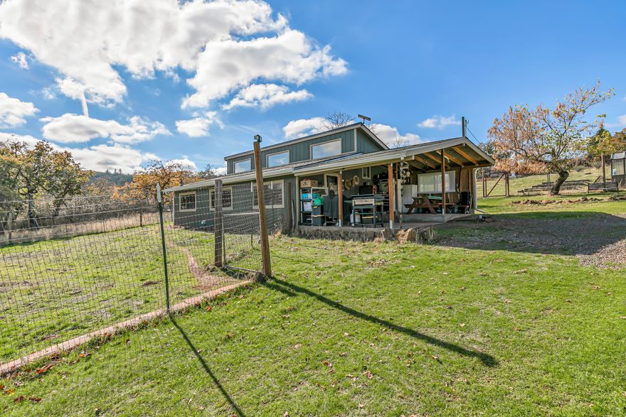 This starter homestead backs to over 200 acres of BLM land with a small but spacious 2-bedroom, 1 bathroom stick-built home. New features and updates include a new roof and gutters, paint inside and out, newly renovated porch/entry, and 3 new mini-splits. The large picture windows and vaulted ceilings make the home feel grand despite its petite size. Outside you'll find a generous garden area with deer fencing, fruit trees (pear, cherry, peach, almond and pomegranate!), and a quaint greenhouse. There's also plenty of space for a whole flock of birds and other small farm animals in the coop and small barn. Views of Mt McLoughlin complete this peaceful homestead retreat. Welcome Home!