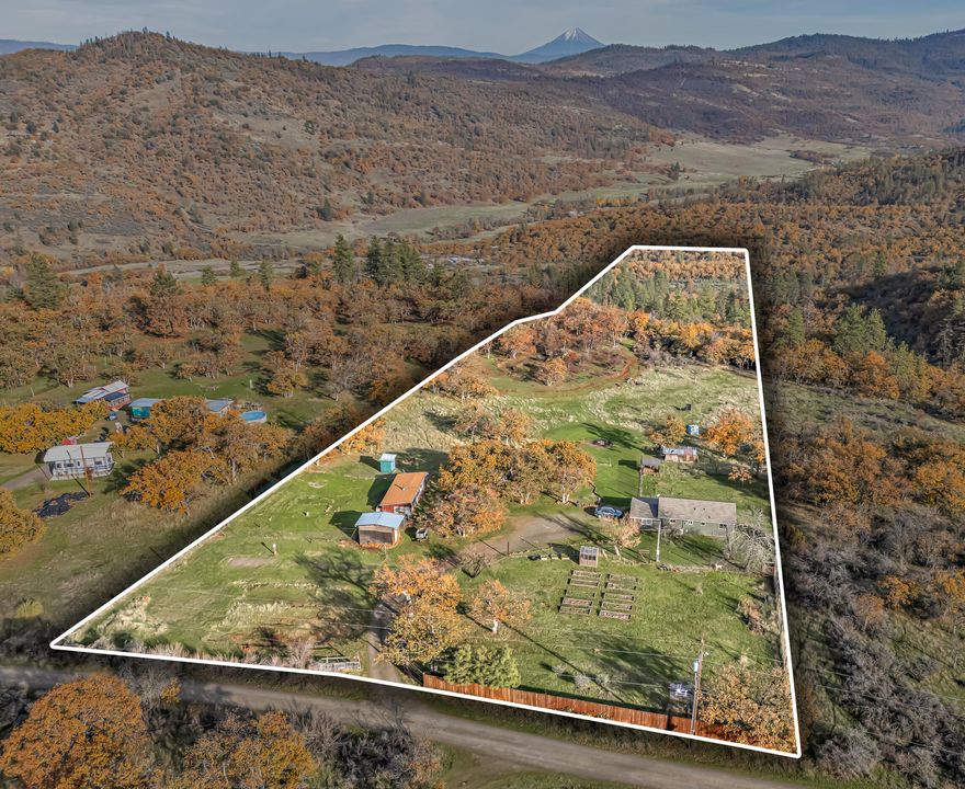 This starter homestead backs to over 200 acres of BLM land with a small but spacious 2-bedroom, 1 bathroom stick-built home. New features and updates include a new roof and gutters, paint inside and out, newly renovated porch/entry, and 3 new mini-splits. The large picture windows and vaulted ceilings make the home feel grand despite its petite size. Outside you'll find a generous garden area with deer fencing, fruit trees (pear, cherry, peach, almond and pomegranate!), and a quaint greenhouse. There's also plenty of space for a whole flock of birds and other small farm animals in the coop and small barn. Views of Mt McLoughlin complete this peaceful homestead retreat. Welcome Home!