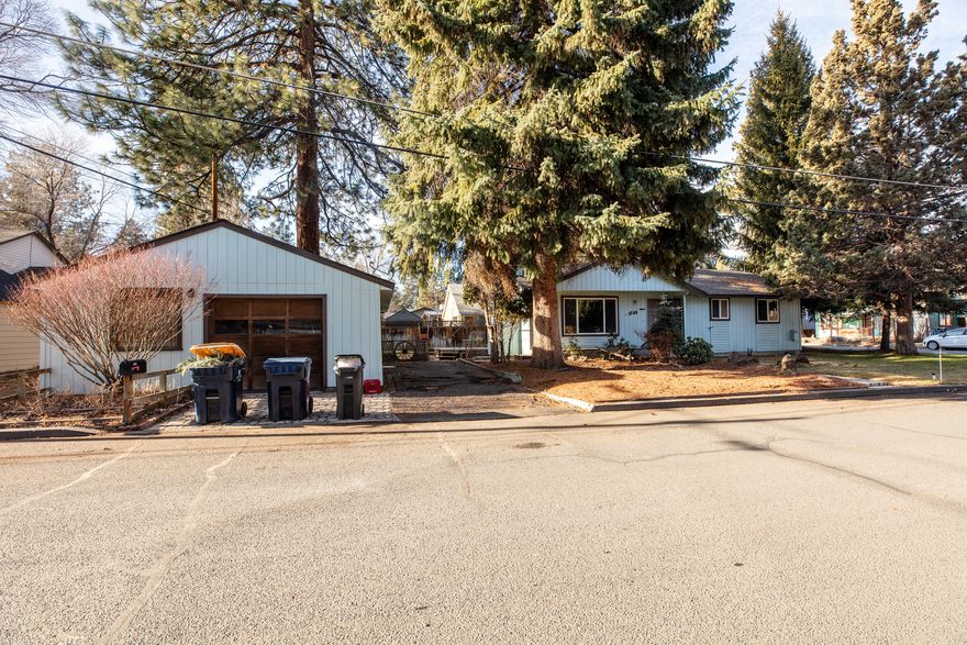 Well cared for single level home with a detached one bedroom ADU / home office.  Centrally located on a corner lot close to the Newport Avenue corridor, schools and parks. The main house has an open floor plan with vaulted ceilings, a cozy gas fireplace and access off the dining area to the south facing deck.  There is a primary suite with a full bath and two additional bedrooms sharing a 2nd bath.  The detached unit is fully contained with a kitchen, stackable w/d, tiled shower and separate bedroom.   Solid core doors and stylish accent finishes throughout the unit.   The corner lot allows plenty of natural light to both structures and the location is an ideal launching pad for enjoying the trails and amenities of NW Bend.